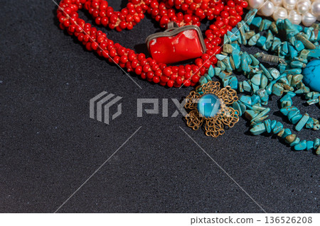 Beaded Necklaces and Brooch Jewelry on black background copy space 136526208
