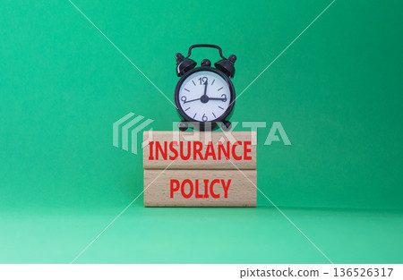 Insurance Policy symbol. Concept word Insurance Policy on wooden blocks. Beautiful green background. Business and Insurance Policy concept. Copy space 136526317