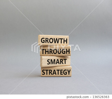 Smart strategy symbol. Wooden blocks with words Growth through smart strategy. Beautiful grey background. Business and Smart strategy concept. Copy space 136526363