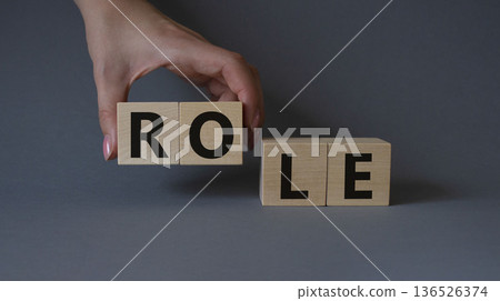 Role symbol. Concept word Role on wooden cubes. Businessman hand. Beautiful grey background. Business and Role concept. Copy space. Role symbol. Concept word Role on wooden cubes. Businessman hand. Beautiful grey background. Business and Role concept. Copy space. 136526374