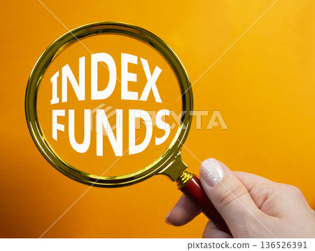 Index Funds symbol. Magnifying Glass with words Index Funds. Businessman hand. Beautiful orange background. Business and Index Funds concept. Copy space. Index Funds symbol. Magnifying Glass with words Index Funds. Businessman hand. Beautiful orange background. Business and Index Funds concept. Copy space. 136526391