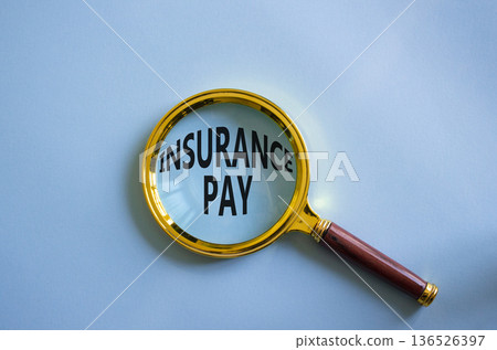 Insurance Pay symbol. Magnifying Glass with words Insurance Pay. Beautiful blue background. Business and Insurance Pay concept. Copy space. Insurance Pay symbol. Magnifying Glass with words Insurance Pay. Beautiful blue background. Business and Insurance Pay concept. Copy space. 136526397
