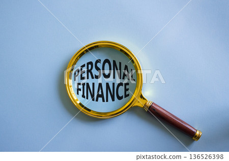Personal Finance symbol. Magnifying Glass with words Personal Finance. Beautiful blue background. Business and Personal Finance concept. Copy space. 136526398