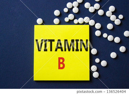 Vitamin B symbol. Concept word Vitamin B on yellow note. Beautiful deep blue background with pills. Medicine and Vitamin B concept. Copy space Vitamin B symbol. Concept word Vitamin B on yellow note. Beautiful deep blue background with pills. Medicine and Vitamin B concept. Copy space 136526404