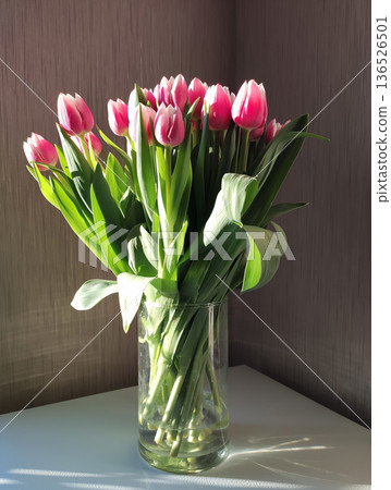 A spring bouquet of tulips on a wooden table. A spring bouquet of tulips on a wooden table. 136526501