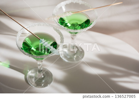 Green Martini Cocktails with Rock Candy. Festive St. Patricks Day Celebration Still Life Green Martini Cocktails with Rock Candy. Festive St. Patricks Day Celebration Still Life 136527005