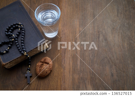 Bible, rosary, bread, water for fasting lent 136527015