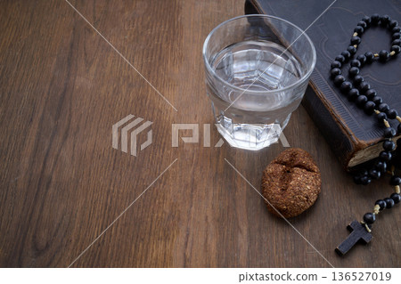 Fasting for lent with water, bread, bible, and rosary beads Fasting for lent with water, bread, bible, and rosary beads 136527019