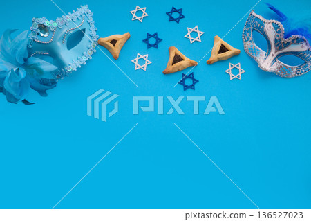 Purim holiday symbols with hamantaschen and carnival masks Purim holiday symbols with hamantaschen and carnival masks 136527023