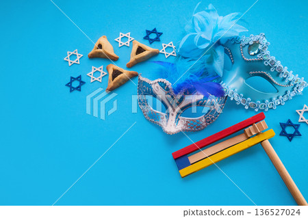 Purim celebration with hamantaschen, masks, gragger, and stars of david 136527024