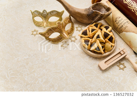 Purim celebration items with hamantaschen, masks, esther scroll 136527032