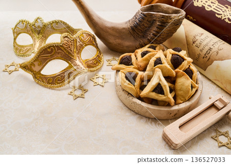 Purim holiday attributes featuring masks, hamantaschen, and shofar 136527033