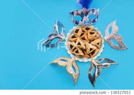 Purim celebration with hamantashen cookies and carnival masks Purim celebration with hamantashen cookies and carnival masks 136527051
