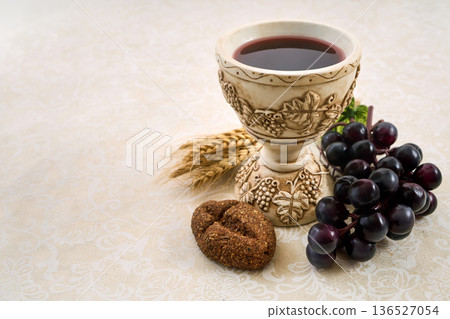 Holy sacrament eucharist symbols with chalice, bread, wheat, grapes Holy sacrament eucharist symbols with chalice, bread, wheat, grapes 136527054