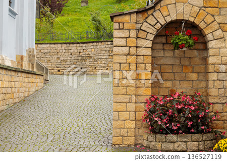 cell element street decorative object with flower pot in cobble stone street tile and old brick walls historical district landmark cell element street decorative object with flower pot in cobble stone street tile and old brick walls historical district landmark 136527119