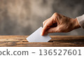 Voting Time: Woman's Hand Casting Ballot, Focus on Action, Minimalist Background 136527601