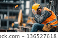 Construction Worker in Pain, Hard Work Concept, Industrial Area Background, Medium Shot, Yellow Helmet, Orange Vest 136527618