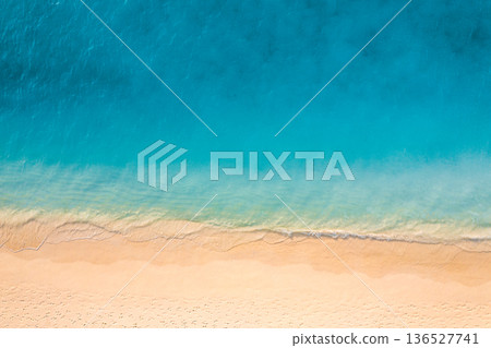 Gold sandy shore blue waves calm water tropical Mediterranean beach background 136527741