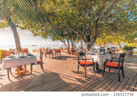 Peaceful sunset outdoors restaurant exotic hotel resort dining Maldives luxury Peaceful sunset outdoors restaurant exotic hotel resort dining Maldives luxury 136527756