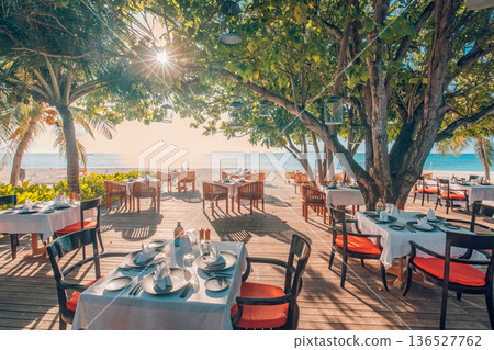 Relaxing evening beach cafe outdoor seating luxury Maldives island resort decor Relaxing evening beach cafe outdoor seating luxury Maldives island resort decor 136527762