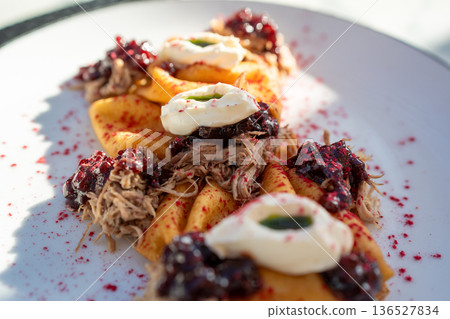 Close up of blini topped with meat and cream Close up of blini topped with meat and cream 136527834