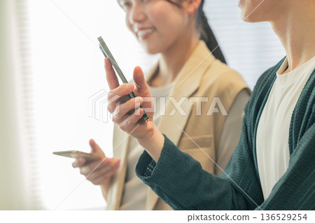 Men and women chatting in the office Men and women chatting in the office 136529254