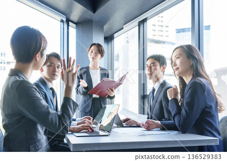 Businessman asking a question at a meeting 136529383