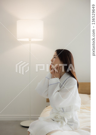 A woman relaxing at bed A woman relaxing at bed 136529649