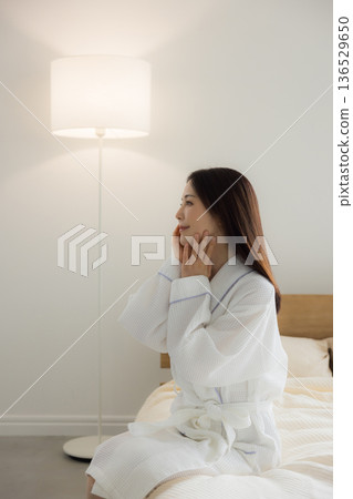 A woman relaxing at bed A woman relaxing at bed 136529650