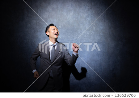 Businessman on a dark background 136529706