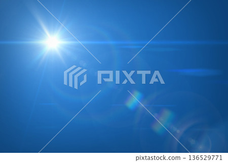 Sun flare against clear blue sky. Solal lens flare and sky. Sun flare against clear blue sky. Solal lens flare and sky. 136529771