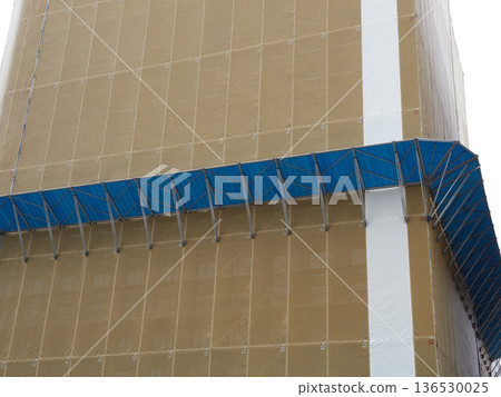 Soundproofing sheets and fall prevention measures at a construction site for a building in town 136530025