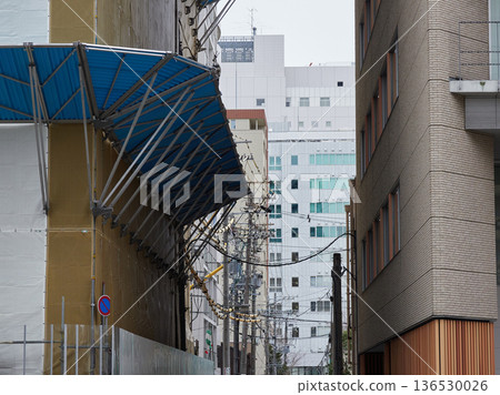 Soundproofing sheets and fall prevention measures at a construction site for a building in town Soundproofing sheets and fall prevention measures at a construction site for a building in town 136530026