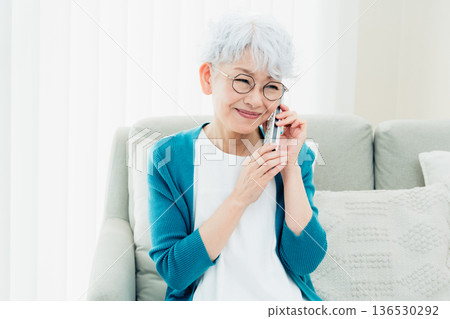Senior woman talking on landline phone Senior woman talking on landline phone 136530292