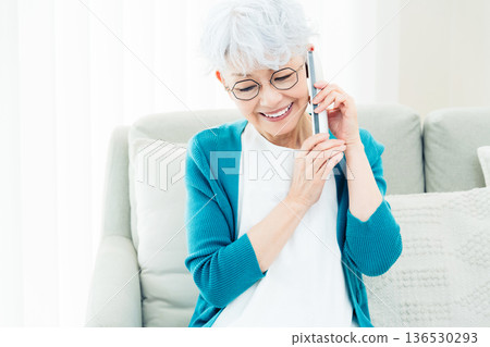Senior woman talking on landline phone Senior woman talking on landline phone 136530293