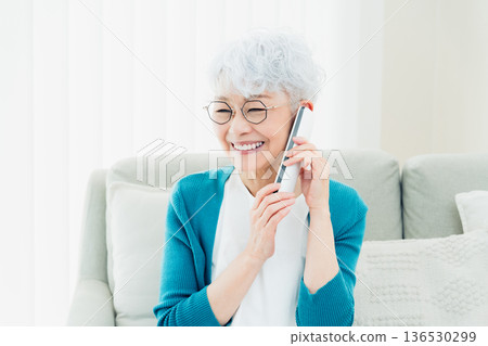 Senior woman talking on landline phone Senior woman talking on landline phone 136530299
