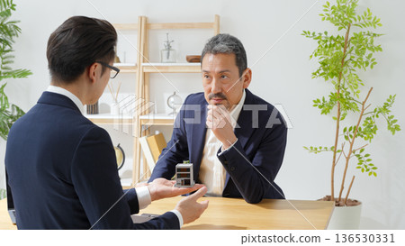 Men negotiating business Men negotiating business 136530331