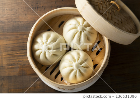 Steaming meat buns in a bamboo steamer 136531396