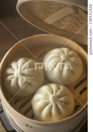 Steaming meat buns in a bamboo steamer Steaming meat buns in a bamboo steamer 136531428