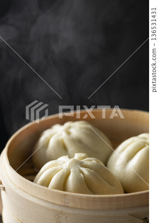 Steaming meat buns in a bamboo steamer 136531431