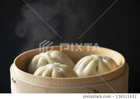 Steaming meat buns in a bamboo steamer Steaming meat buns in a bamboo steamer 136531432