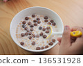 Breakfast bowl with cereal and milk on wooden table 136531928