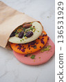 Colorful sweets in a brown paper bag for a tasty snack 136531929