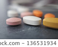 Different types of pills on a dark surface 136531934