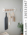 Kitchen items are arranged on a wall rack in a home 136531947