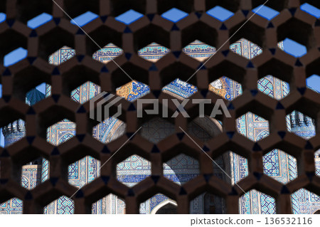 Sher Dor Madrasah behind the hexagonal grid in Registan Square Sher Dor Madrasah behind the hexagonal grid in Registan Square 136532116