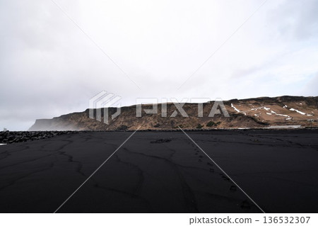 The dramatic black sand beach and sheer cliffs of Reynisfjara in Vik, Iceland The dramatic black sand beach and sheer cliffs of Reynisfjara in Vik, Iceland 136532307