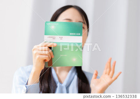 A woman surprised to see a bankbook A woman surprised to see a bankbook 136532338