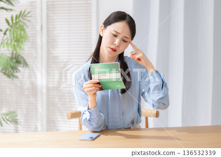 A woman surprised to see a bankbook A woman surprised to see a bankbook 136532339