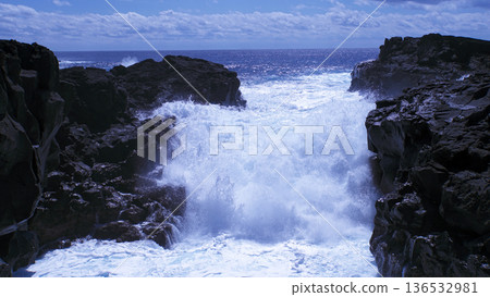 The sea sparkling in the sunlight and the white waves crashing violently against the rocks The sea sparkling in the sunlight and the white waves crashing violently against the rocks 136532981